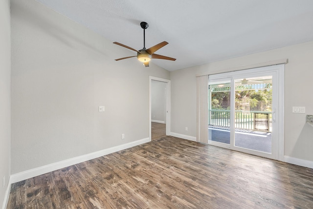 spare room with ceiling fan, vaulted ceiling, and dark hardwood / wood-style flooring