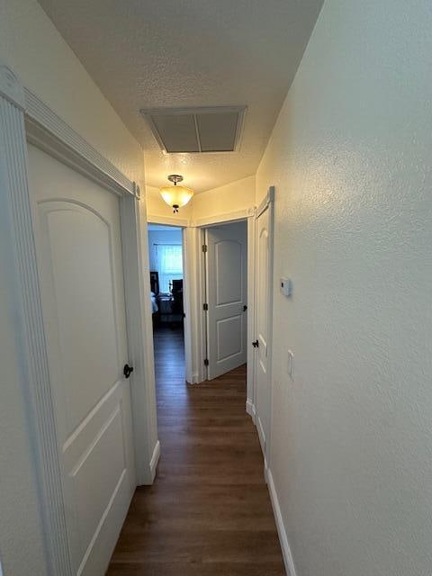 corridor with dark wood-type flooring