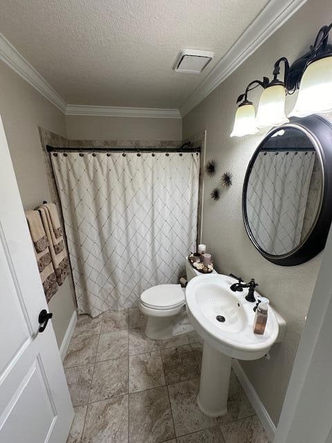 bathroom featuring toilet, crown molding, a textured ceiling, and tile patterned flooring