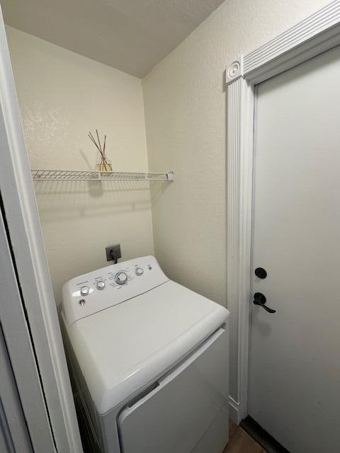 clothes washing area featuring washer / clothes dryer