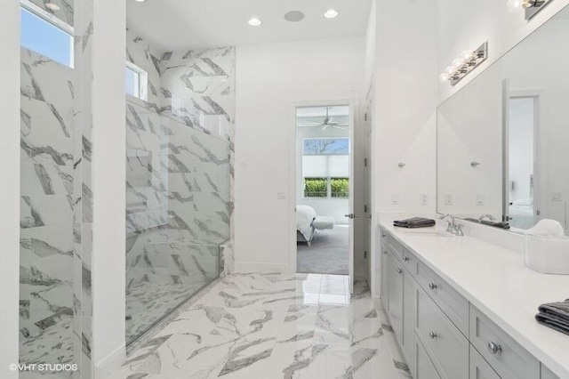 bathroom with vanity and a tile shower