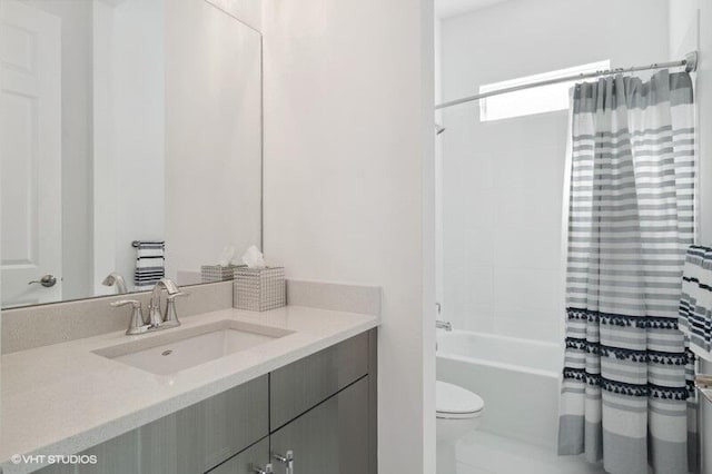 full bathroom with toilet, vanity, and shower / bathtub combination with curtain