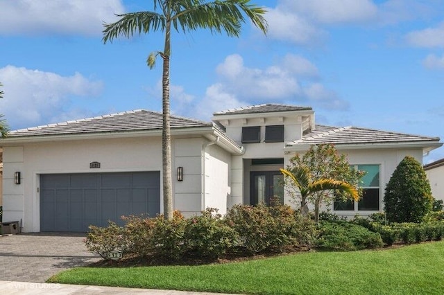 view of front of house with a garage and a front yard