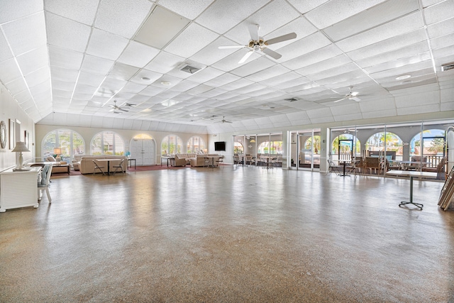 interior space with a drop ceiling and plenty of natural light