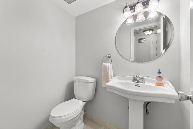 bathroom featuring toilet and tile patterned floors