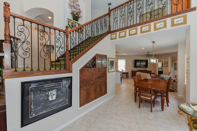 interior space with a high ceiling and ceiling fan