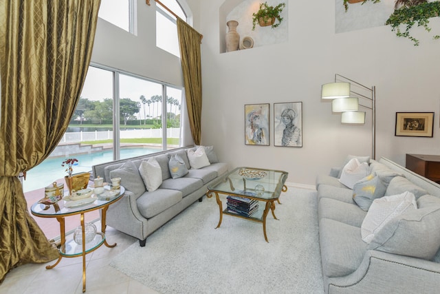 living room with light tile patterned flooring and a high ceiling