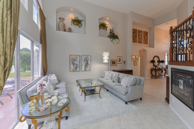 living room featuring a high ceiling and light tile patterned floors