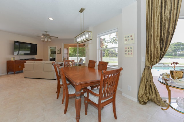 tiled dining room featuring ceiling fan