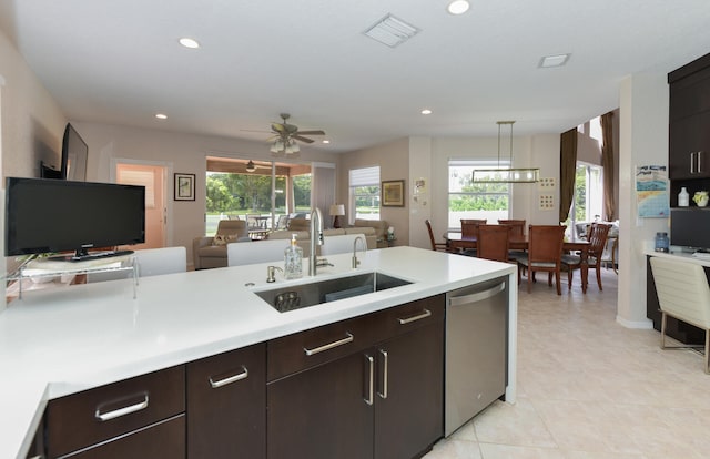 kitchen featuring sink, a healthy amount of sunlight, dishwasher, and decorative light fixtures