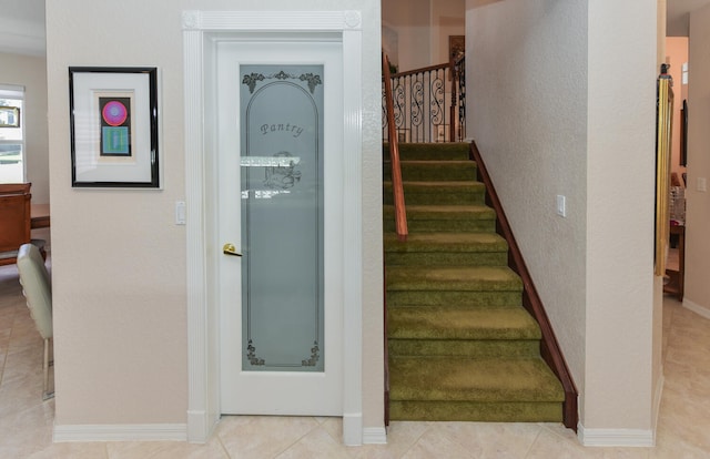 staircase with tile patterned floors