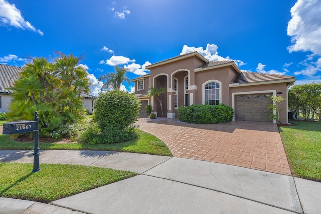 mediterranean / spanish house featuring a front yard