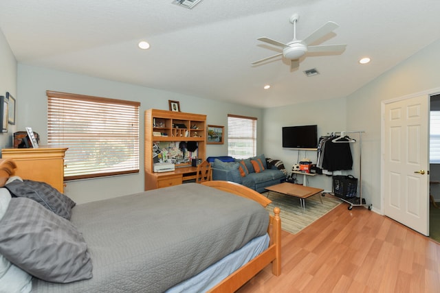 bedroom featuring multiple windows, wood-type flooring, lofted ceiling, and ceiling fan