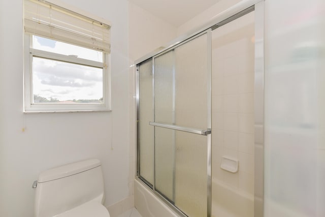 bathroom with toilet and enclosed tub / shower combo