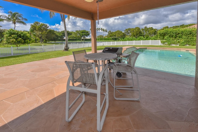 view of swimming pool featuring a yard and a patio area