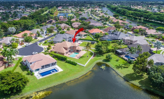 birds eye view of property with a water view