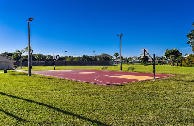 view of sport court with a yard