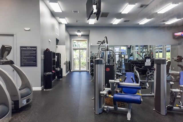 exercise room featuring a high ceiling