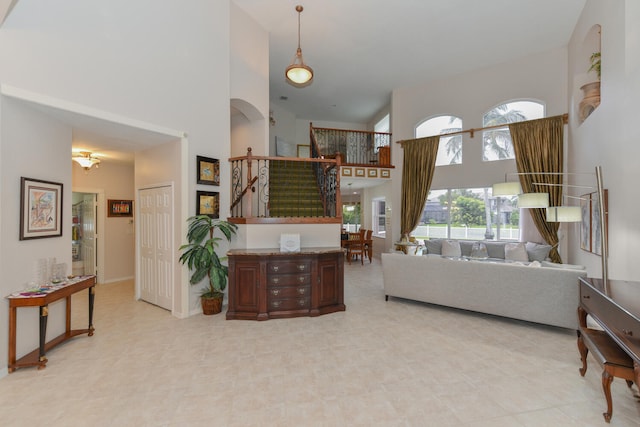 living room featuring a towering ceiling