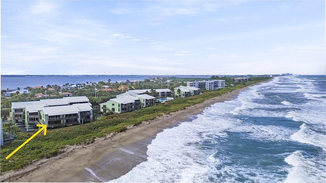 drone / aerial view featuring a view of the beach and a water view