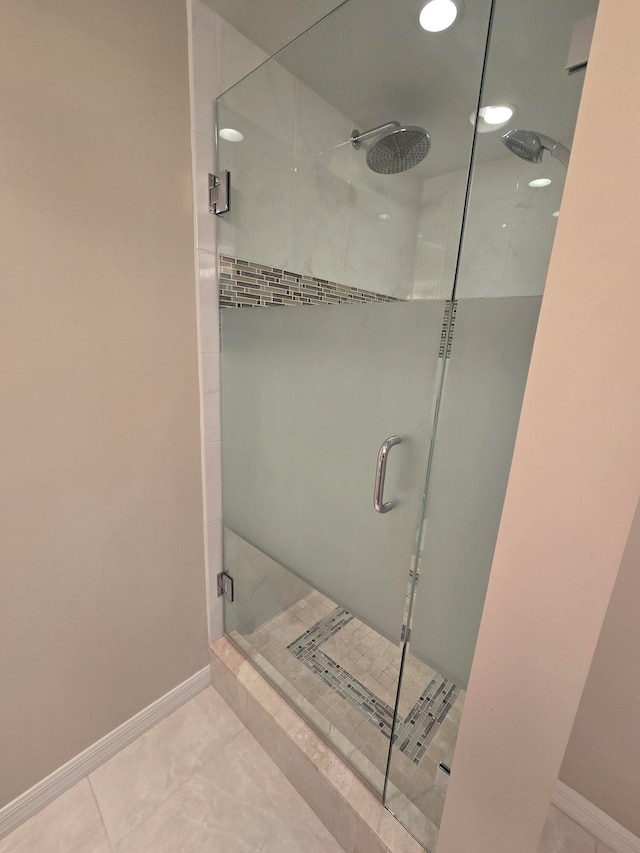 bathroom with tile patterned floors and a shower with door