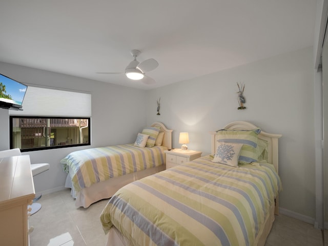 bedroom featuring light tile patterned floors and ceiling fan