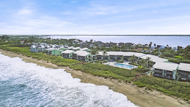 birds eye view of property featuring a water view and a beach view