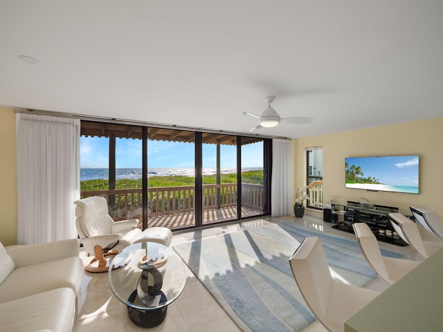 tiled living room with floor to ceiling windows and ceiling fan