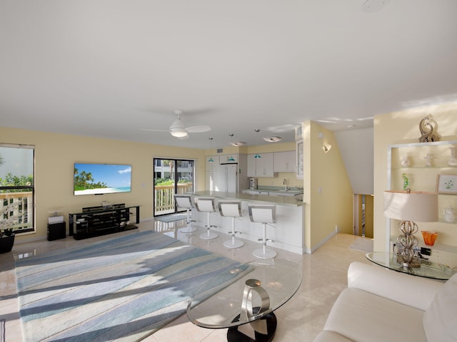 dining area with light tile patterned floors, ceiling fan, and sink