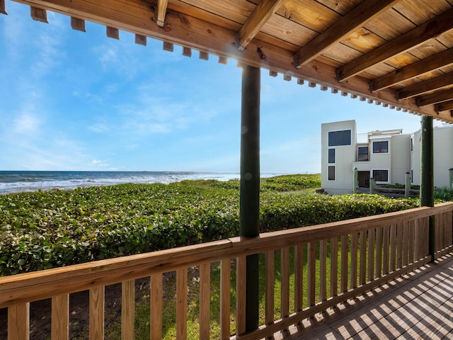 exterior space with a water view and a beach view