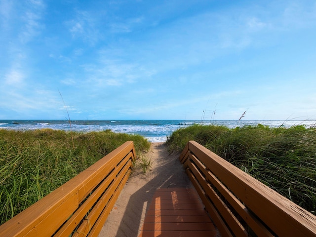 surrounding community with a view of the beach and a water view