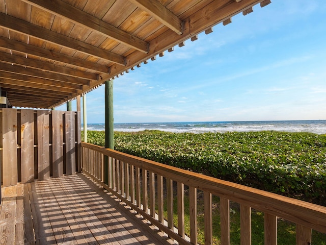 wooden terrace with a water view and a beach view