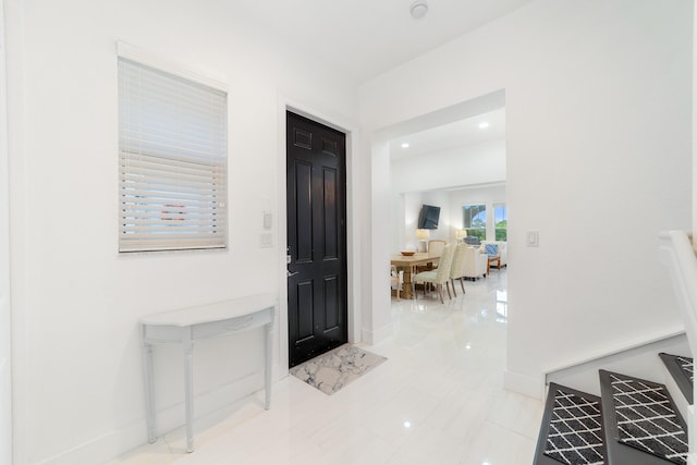 foyer featuring baseboards