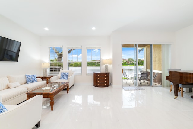 living room featuring a water view and a wealth of natural light