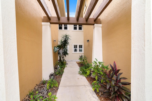 view of exterior entry featuring stucco siding