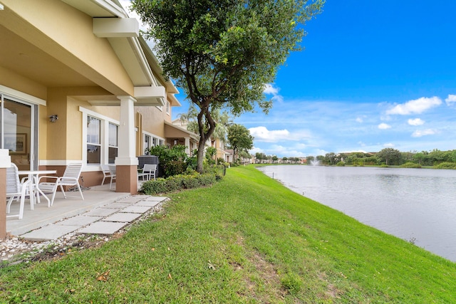 view of yard with a patio area and a water view