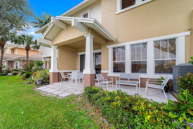 rear view of house featuring a yard and a patio