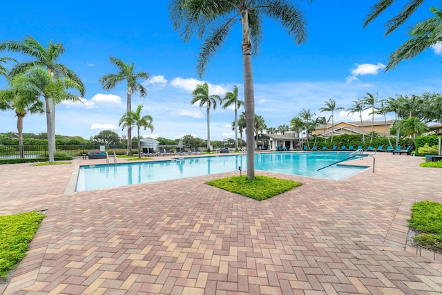 community pool featuring a patio area and fence