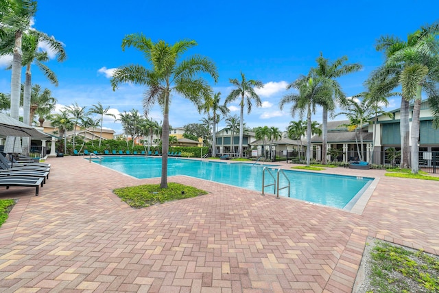 community pool featuring a patio area and fence