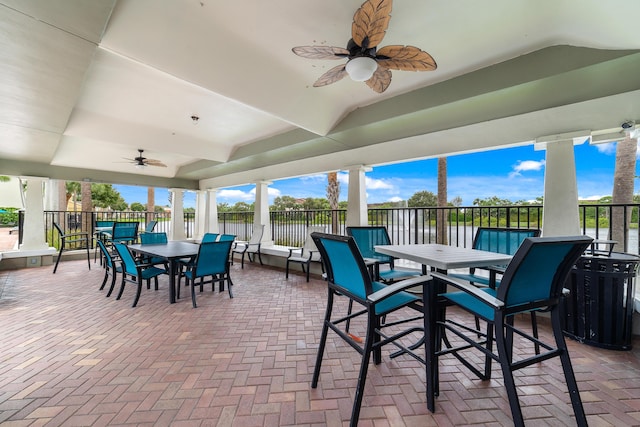 view of patio / terrace with outdoor dining area, ceiling fan, and fence