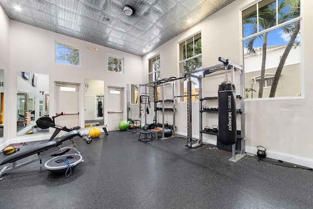 workout area with a high ceiling