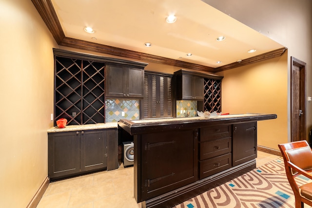 bar with ornamental molding, dark brown cabinetry, light tile patterned flooring, and backsplash