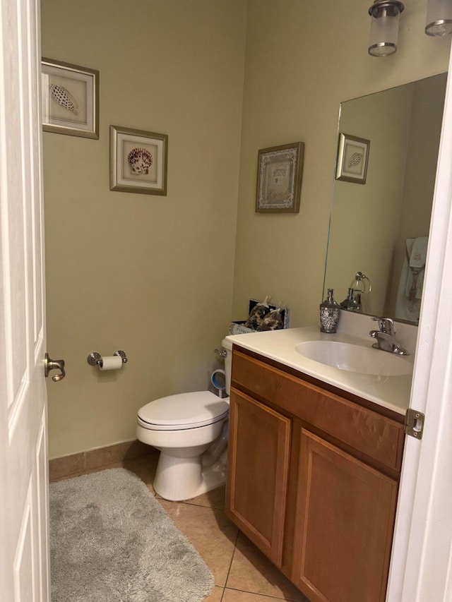 bathroom featuring tile patterned floors, vanity, and toilet