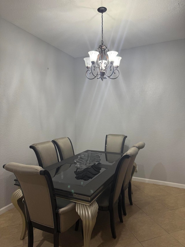 dining room featuring tile patterned floors and a notable chandelier