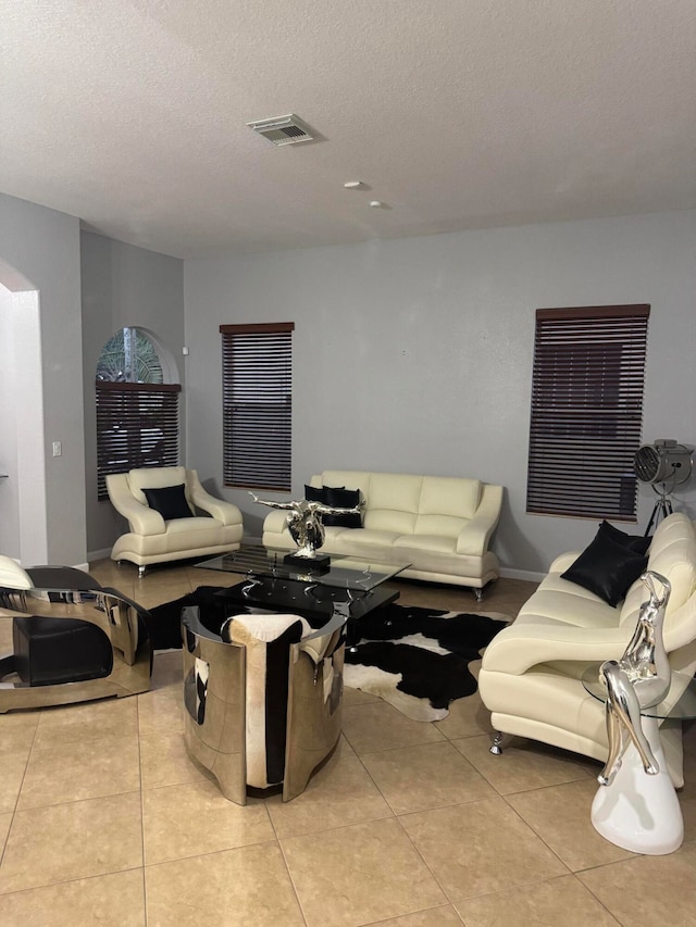 living room with light tile patterned floors and a textured ceiling