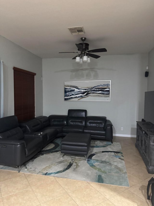 living room featuring ceiling fan and light tile patterned flooring