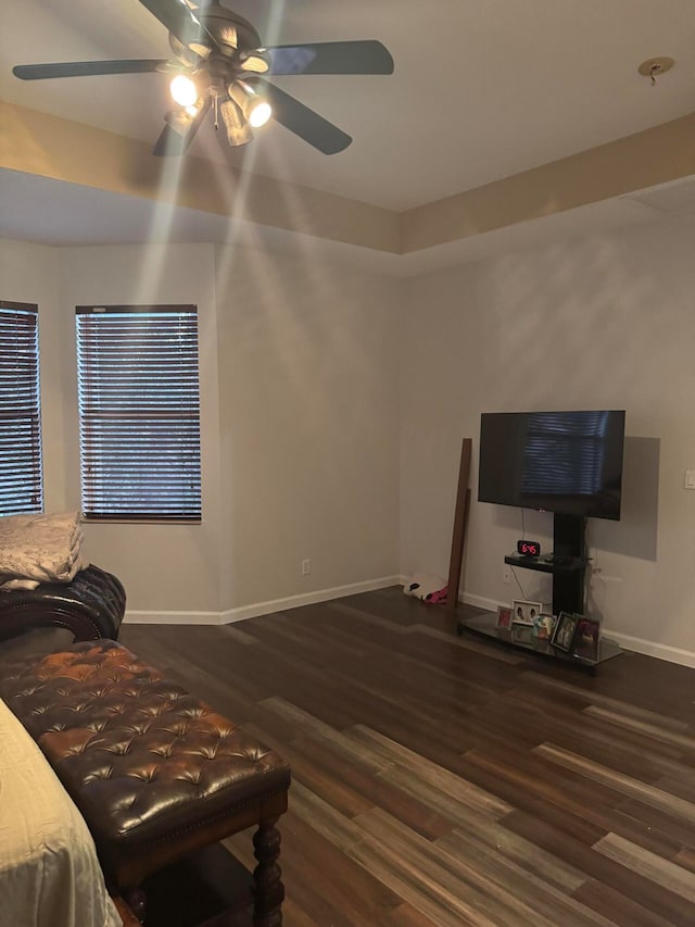 living area featuring dark hardwood / wood-style floors and ceiling fan