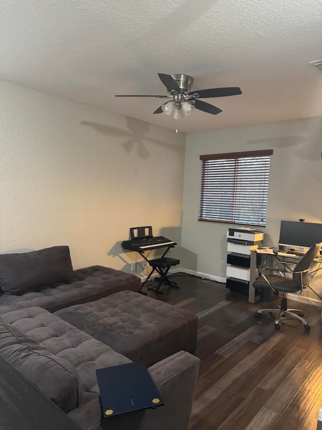 living room featuring a textured ceiling, dark hardwood / wood-style floors, and ceiling fan