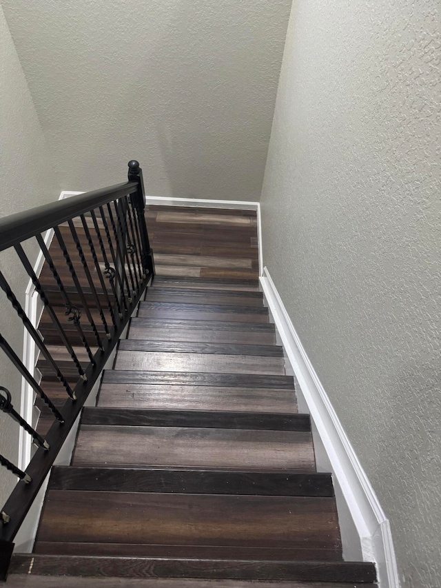 stairs featuring hardwood / wood-style flooring