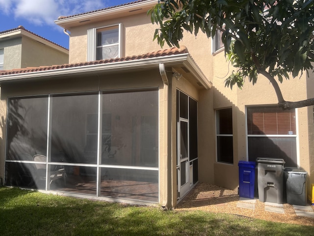 view of home's exterior with a sunroom